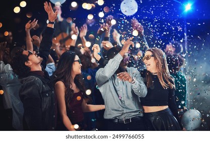 Confetti, people and dance at festival for New Year celebration with smile and fun at nightclub. Music, disco lights and excited for concert with entertainment for memories, break and enjoy party