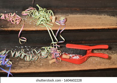 Confetti And Ribbons On Wood Steps And A Dust Pan - Cleaning Up After The Party