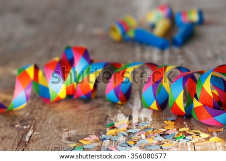 Confetti and streamers on rustic background