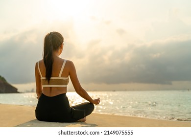 Confidence Asian woman in sportswear do yoga practice exercise on tropical island beach in summer morning. Healthy female enjoy outdoor lifestyle relaxation exercise and meditation on beach vacation - Powered by Shutterstock