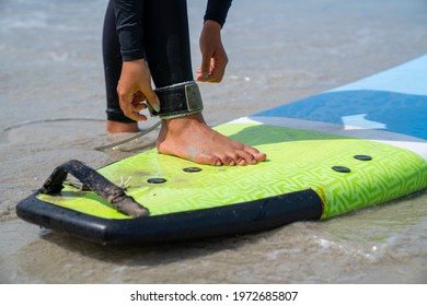 Confidence Asian Woman In Wetsuit Wear Surfboard Safety Leg Rope Before Surfing On Tropical Beach. Healthy Sportswoman Enjoy Outdoor Active Lifestyle Play Extreme Sport Surfing On Summer Vacation.