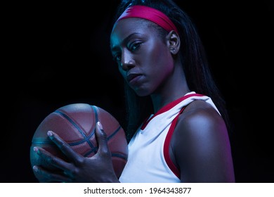 Confidence. Beautiful african-american female basketball player in motion and action in neon light on black background. Concept of healthy lifestyle, professional sport, hobby. Woman in sport. - Powered by Shutterstock