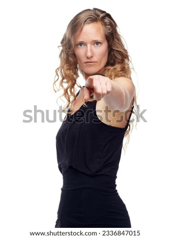 Similar – Close up front portrait of one young mid adult athletic woman in sportswear in gym over dark background, standing in boxing stance with hands and fists, looking at camera