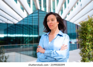 Confidence Businesswoman Portrait With Crossed Hands. Pretty Business Woman 30 Years Old Standing Near Office Building Dressed Blue Shirt. Caucasian Female Business Person Outside