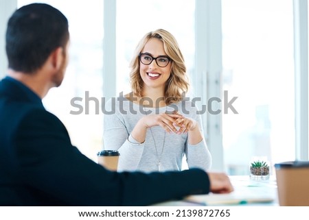 Confidence in the corporate world. Shot of two businesspeople having a meeting in an office.