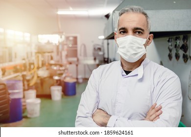 Confidence European High Skilled Worker Middle Age 40-50 Standing Portrait In Factory With Face Mask.