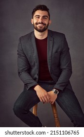 Confidence Is Something That Stays On Trend. Studio Portrait Of A Handsome Young Man Posing Against A Dark Background.