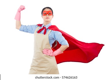 Confidence Superhero House Cleaner Showing Her Powerful Muscle Arm With Wearing Red Cloak And Goggles. Isolated On White Background. Housework And Household Concept.