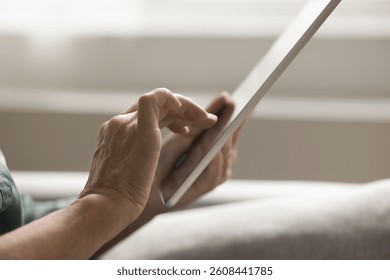 Confidence in using modern tech at older age. Close up cropped shot senior woman hands hold digital tablet type message text on screen make easy online payment choose order purchase at ecommerce store