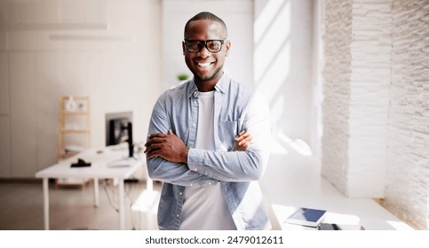 Confident African American Businessman Leads Diverse Team in Office, Creating Innovative Solutions for Success, Professional Portrait of Success - Powered by Shutterstock