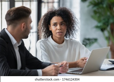 Confident African American businesswoman mentor tutor training intern, giving instructions, using laptop, helping with corporate software, manager consulting client customer at meeting - Shutterstock ID 1746124304