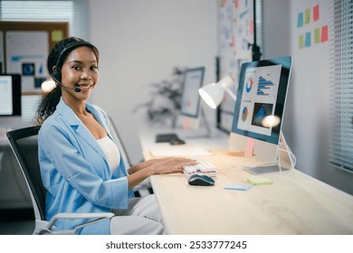 Confident african american businesswoman working joyfully at sleek desk in bustling office, fully engaged with computer, showcasing professionalism and expertise in corporate world - Powered by Shutterstock