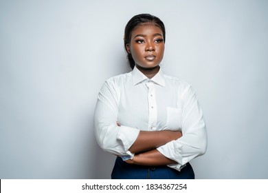 Confident African Business Woman With Arms Folded Looking To Her Left,isolated On A Grey Studio Background-