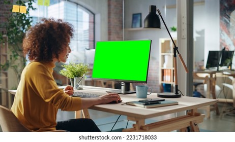 Confident Arab Businesswoman Working on Implementing Modern Business Strategy in Creative Agency. Specialist Writing Corporate Project Plan on Desktop Computer with Green Screen Mock Up Display. - Powered by Shutterstock