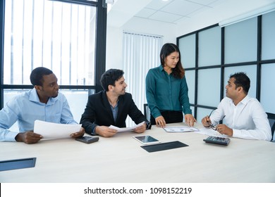 Confident Asian business lady presenting her idea at meeting