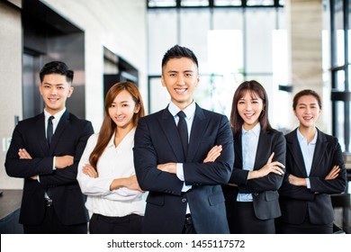Confident Asian Business Team Stands In Office