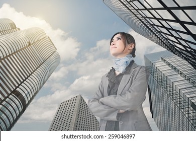 Confident Asian Business Woman Stand And Think, Closeup Portrait With Office Building Background.