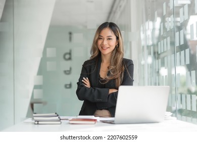 Confident Asian Businesswoman Working  In Office Workstation.