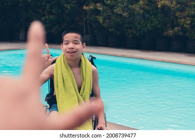 Confident Asian Disabled Child On Wheelchair Hand Made As A Love Symbol On Swimming Pool Background, Concept The Exercises For The Strength Of Muscles With Disability Person.