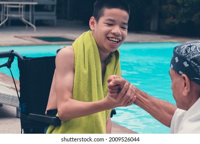 Confident Asian Disabled Child On Wheelchair And Adult With Fun On Swimming Pool Background, Concept The Exercises For The Strength Of Muscles With Disability Person.