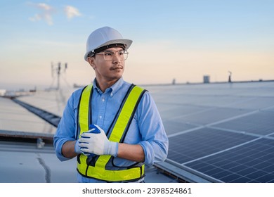 Confident Asian male engineer Get ready to work on inspecting the solar panels. solar power plant concept - Powered by Shutterstock