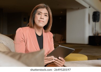 Confident Asian transgender non binary person in business attire at stylish indoor cafe restaurant