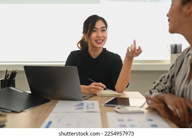 Confident asian woman manager explaining new strategies to coworkers during meeting in office - Shutterstock ID 2254957973