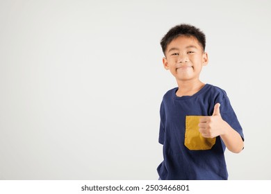 Confident Asian young boy in a studio portrait isolated on white background makes a thumbs up OK sign, symbolizing agreement and success. primary child smile radiates positivity and satisfaction - Powered by Shutterstock