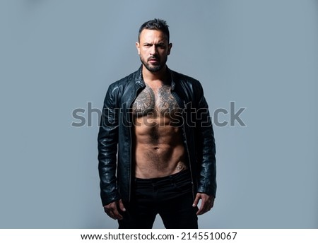 Confident attractive man with serious face. Shirtless macho man. Fashion portrait of brutal guy.