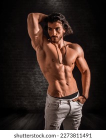Confident, attractive shirtless muscular young man with open vest on - Shutterstock ID 2273811491