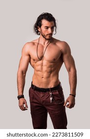 Confident, attractive shirtless muscular young man with open vest on - Shutterstock ID 2273811509