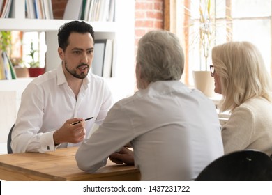 Confident Bank Manager Lawyer Agent Consulting Old Senior Couple Clients At Meeting, Male Financial Advisor Broker Talking To Elder Family Customers Convincing To Make Insurance Investment Loan Deal