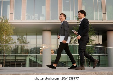 Confident Bankers In Business Suits.  Managers Meeting Near The Office, Discussing A New Project. Financiers Two Is Working On Creating New Jobs.