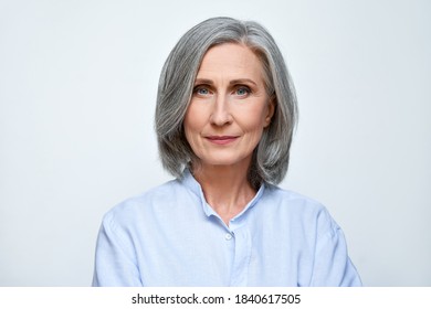 Confident beautiful mature business woman standing isolated on white background. Older senior businesswoman, 60s grey haired lady professional looking at camera, close up face headshot portrait. - Shutterstock ID 1840617505