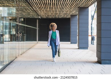 Confident Black Business Woman Walking In Office District Smiling Empowered African American Female Executive Enjoying Successful Corporate Career