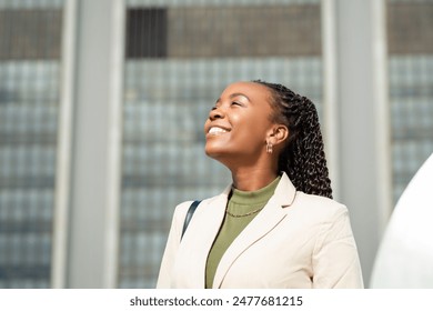 Confident Black Businesswoman Smiling Outdoors in Urban Setting - Powered by Shutterstock