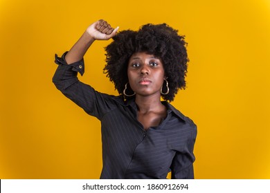 Confident black woman protesting against racial discrimination isolated on yellow background - Young diverse african woman showing black lives matter gesture - stop racism, human rights concept - Powered by Shutterstock