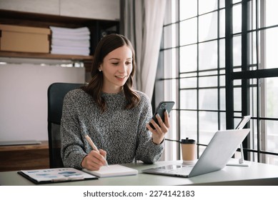 Confident business expert attractive smiling young woman holding digital tablet  on desk in creative office. - Shutterstock ID 2274142183