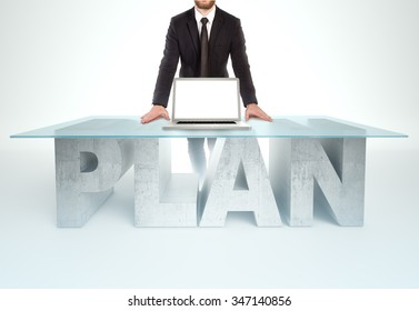 Confident Business Man Leaning On PLAN Table With Open Laptop Bussines Concept