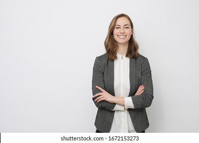 Confident business woman and person smiling at the camera looking professional and executive and having arms crossed, isolated on white background - Shutterstock ID 1672153273