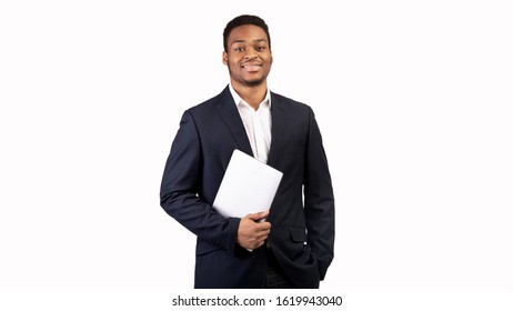 Confident Businessman. Afro Guy Holding Laptop Looking At Camera, Isolated Over White Wall, Copyspace