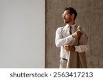 Confident businessman in formal wear looking away in modern office	