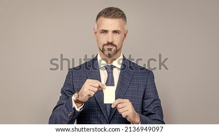 confident businessman man in suit showing credit card for copy space, business card