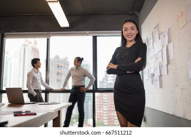 Confident businessman in office with blur business people working background.Work space concept. - Shutterstock ID 667511212