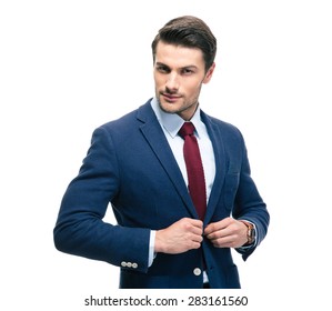 Confident Businessman Putting On Suit Jacket Isolated On A White Background. Looking At Camera