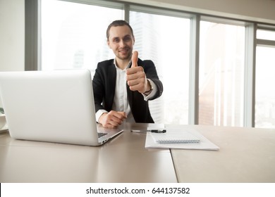 Confident Businessman Showing Thumbs Up Gesture At Desk In Office. Entrepreneur Satisfied With Work Results. CEO Supports Good Decision, Recommends Proven Solution. Company Leader Like Successful Idea