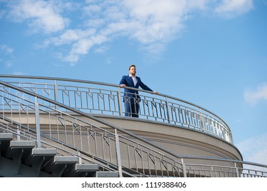 Confident businessman stand on balcony on cloudy blue sky. Man in formal wear outdoor. Looking to the future. Thinking about new possibilities. Confidence and charisma. Male fashion. Best manager ever