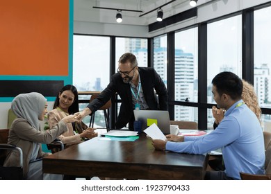 Confident Businessman Standing Congratulate To Multicultural Corporate Colleagues At Meeting Room In The Modern Office. Diverse Corporate Colleagues