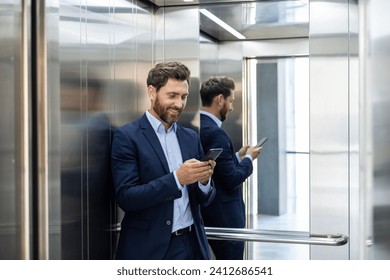 Confident businessman in a suit smiling at his phone in an elevator, reflecting success and connectivity. - Powered by Shutterstock