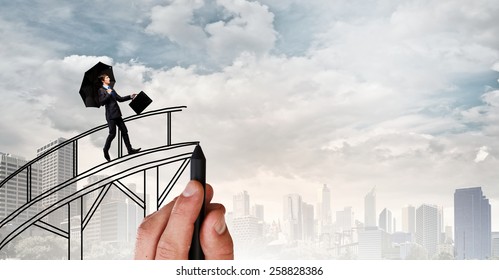 Confident businessman walking on drawn bridge over gap